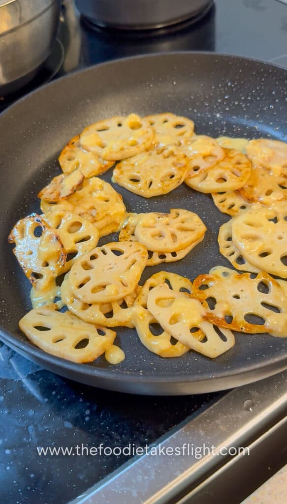 Lotus root browning in a skillet until golden and crisp