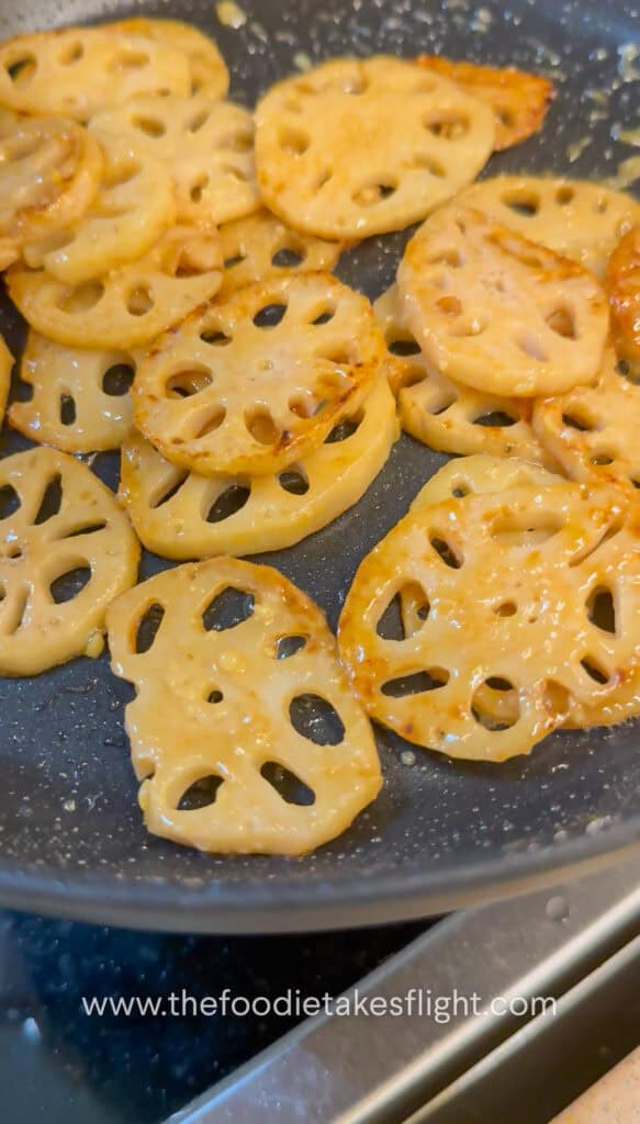 Lotus root browning in a skillet until golden and crisp