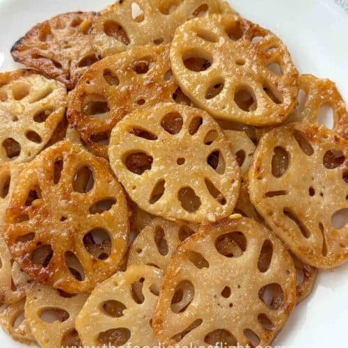 Pan-fried lotus root slices coated in lemon miso sauce and topped with sesame seeds