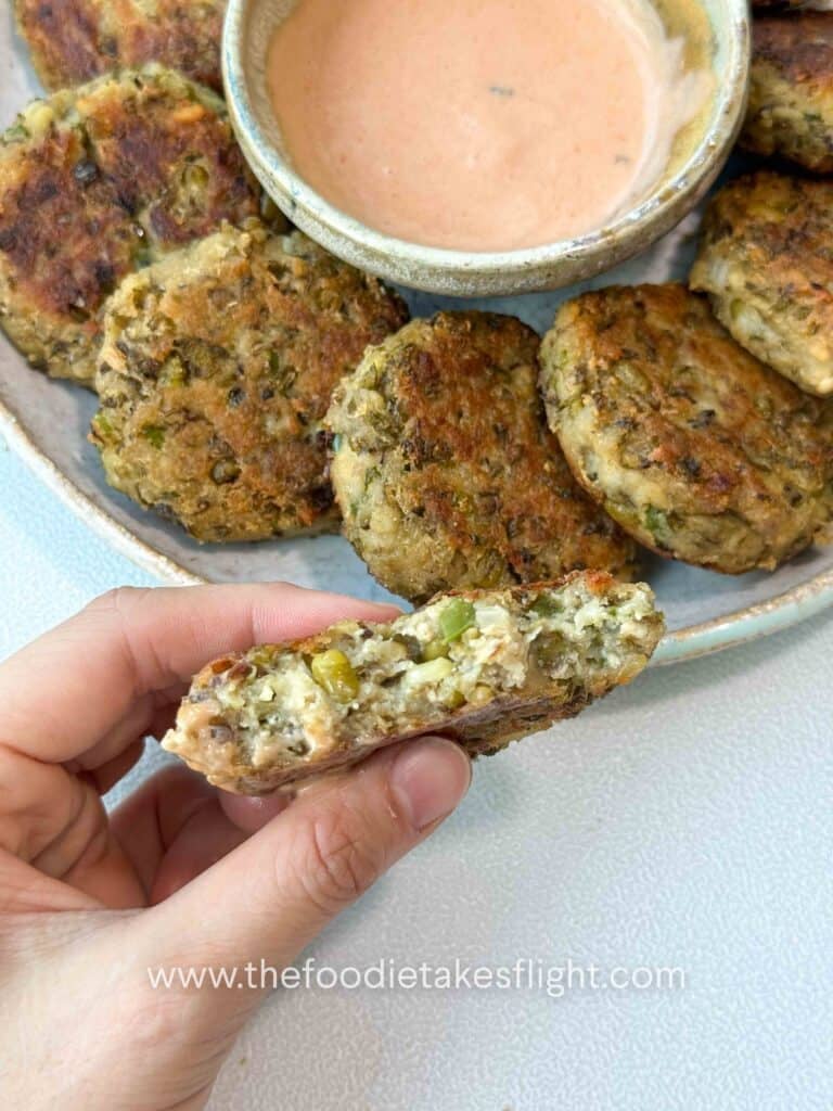 Close-up of crispy mung bean patties showing a textured interior made with tofu and vegetable