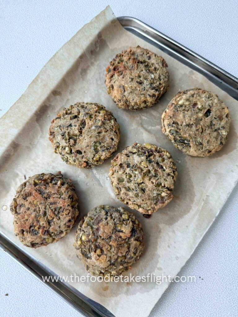 baked mung bean patties on a lined baking tray