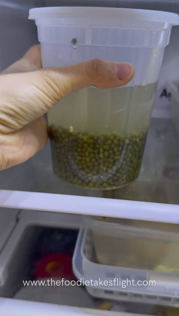 Soaked mung beans in a deli container