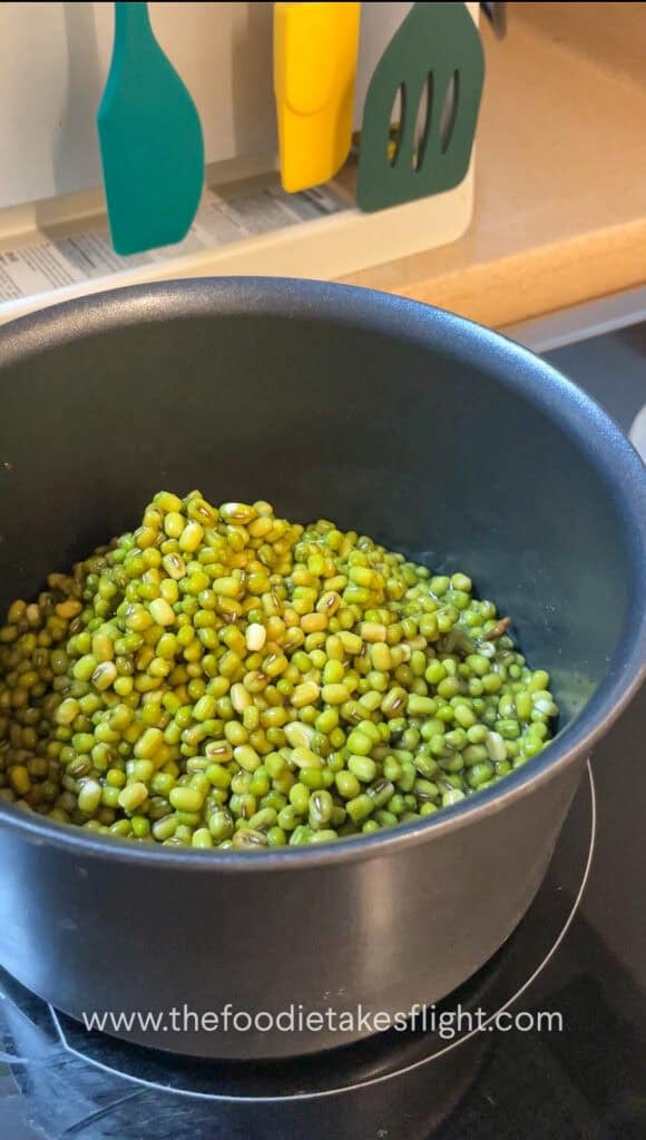 Soaked mung beans in a pot with vegetable bouillon