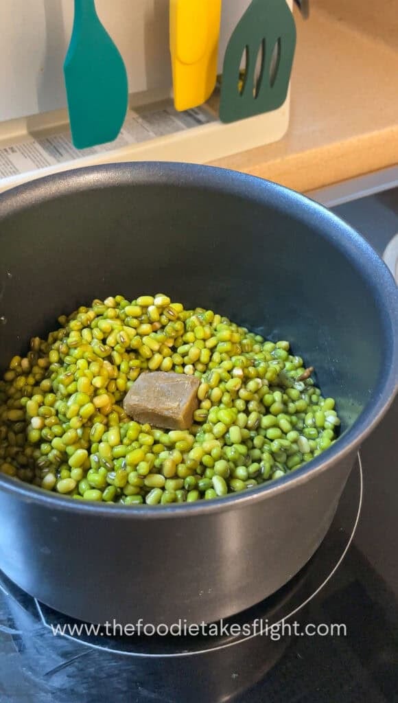 Soaked mung beans in a pot with vegetable bouillon