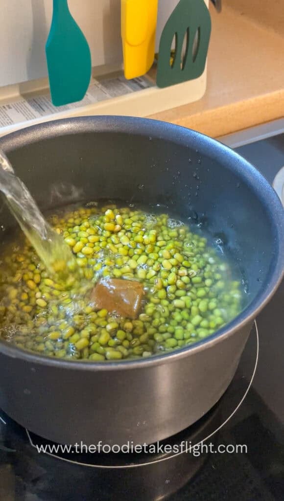 Soaked mung beans in a pot with vegetable bouillon