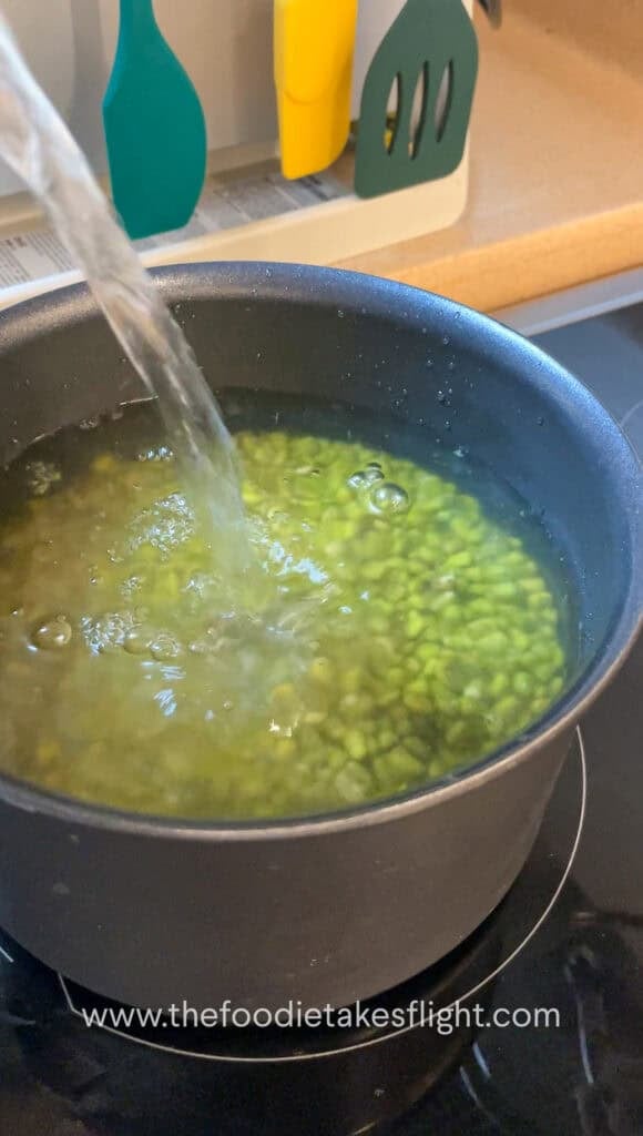 Soaked mung beans in a pot with vegetable bouillon