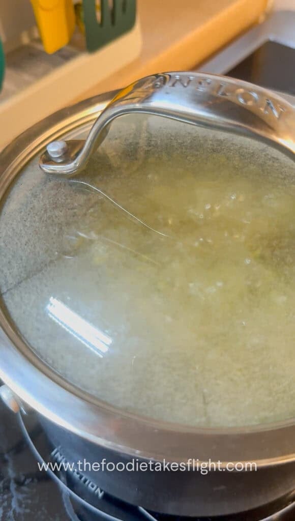 Soaked mung beans in a pot with vegetable bouillon