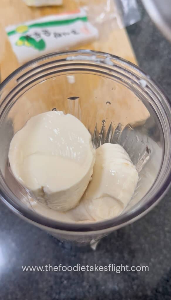 Silken tofu being blended into a smooth creamy sauce