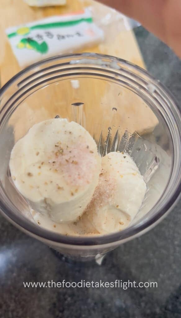 Silken tofu being blended into a smooth creamy sauce