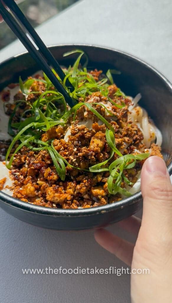 Mixing the creamy mapo tofu udon noodles