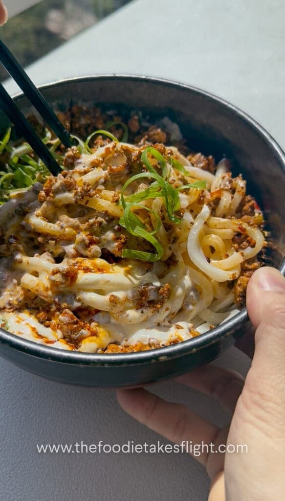 Mixing the creamy mapo tofu udon noodles