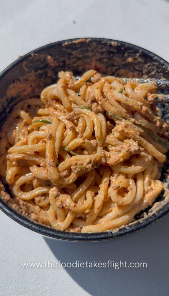 Mixing the creamy mapo tofu udon noodles