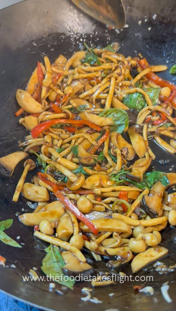 Finished mushroom kra pao in a wok