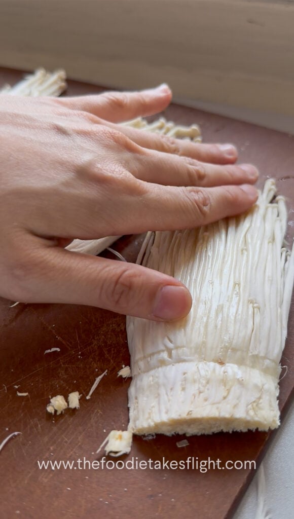slicing enoki mushrooms
