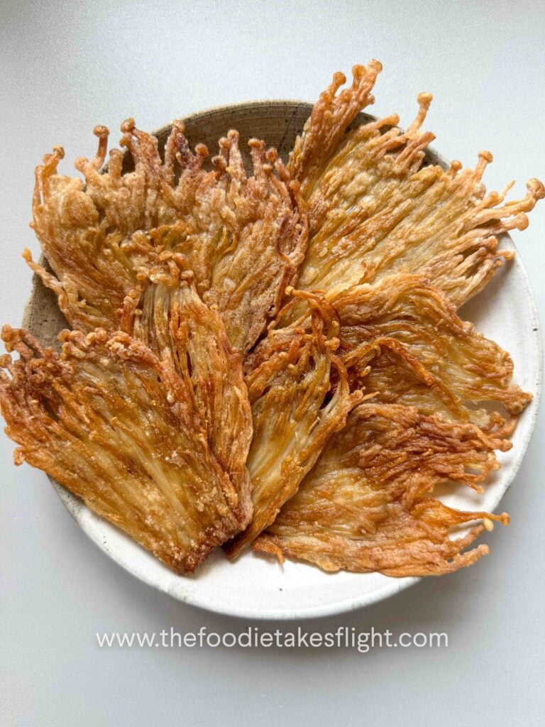 Crispy pan-fried enoki mushrooms in a bowl