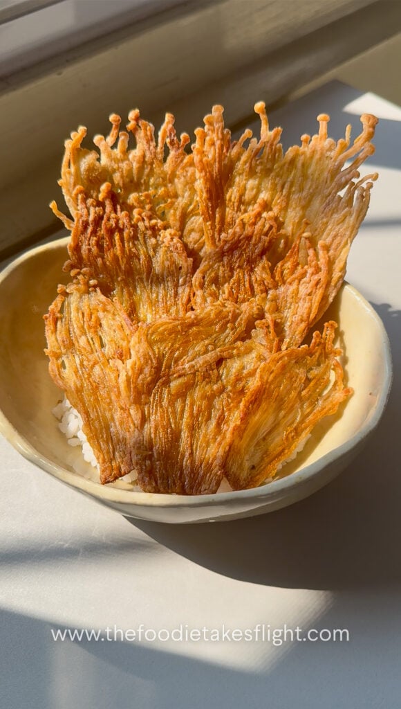 Crispy pan-fried enoki mushrooms in a bowl