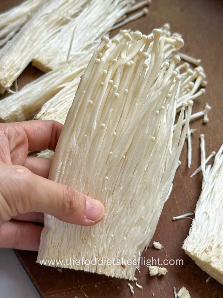 slicing enoki mushrooms