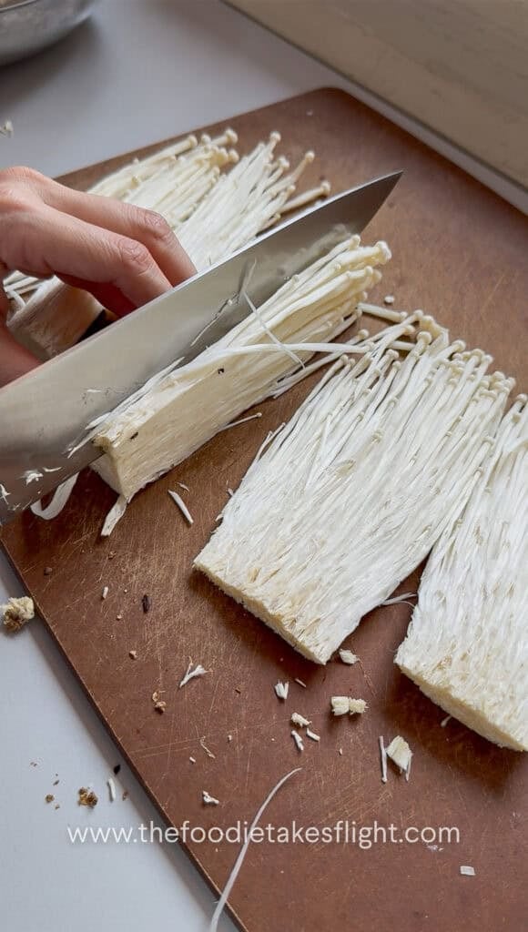 slicing enoki mushrooms