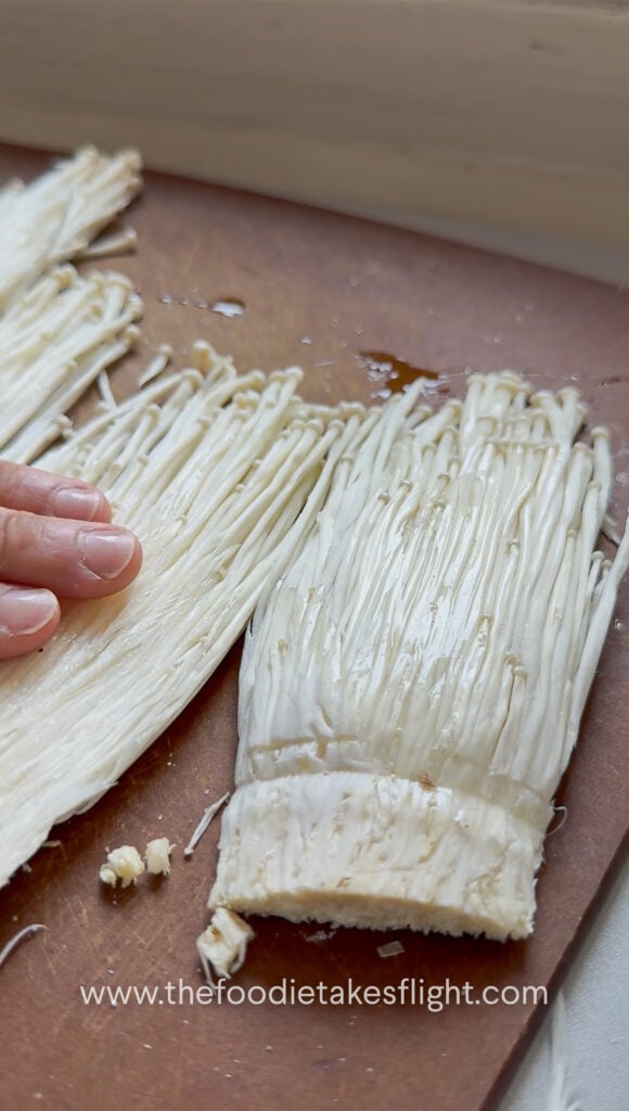 slicing enoki mushrooms