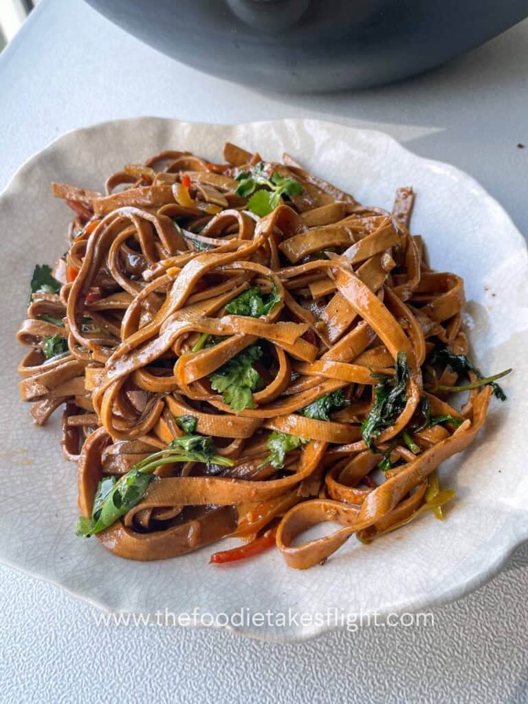 stir-fried beancurd sheets served in a bowl with cilantro