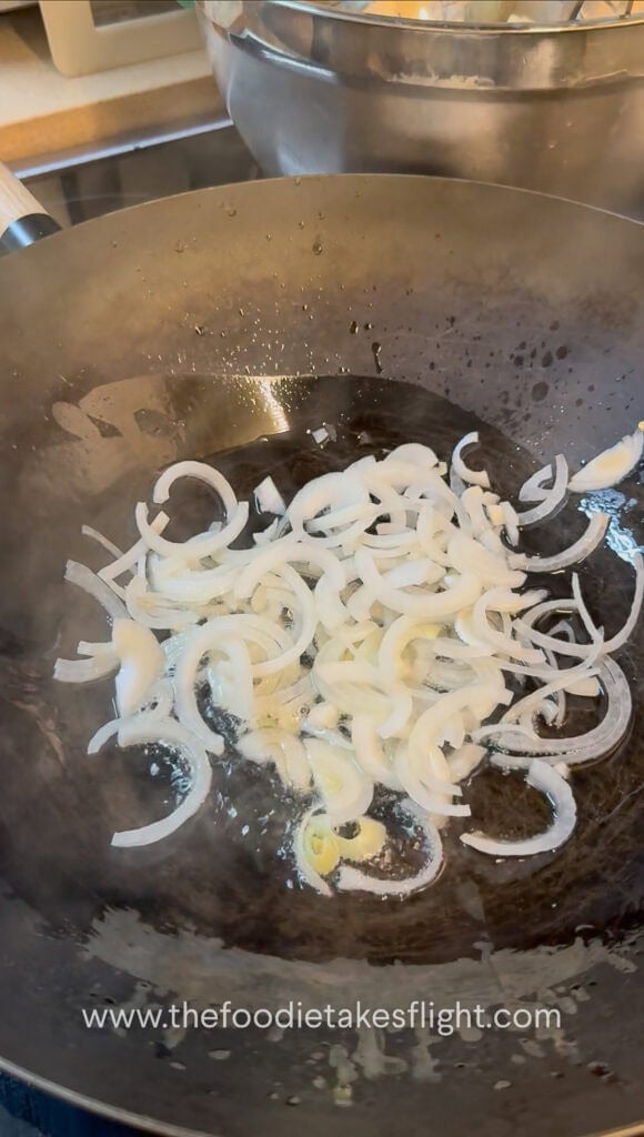 stir-frying aromatics in a steel wok