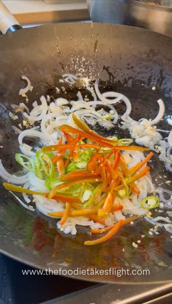 stir-frying aromatics in a steel wok