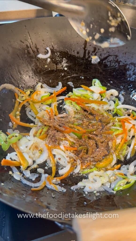 stir-frying aromatics in a steel wok