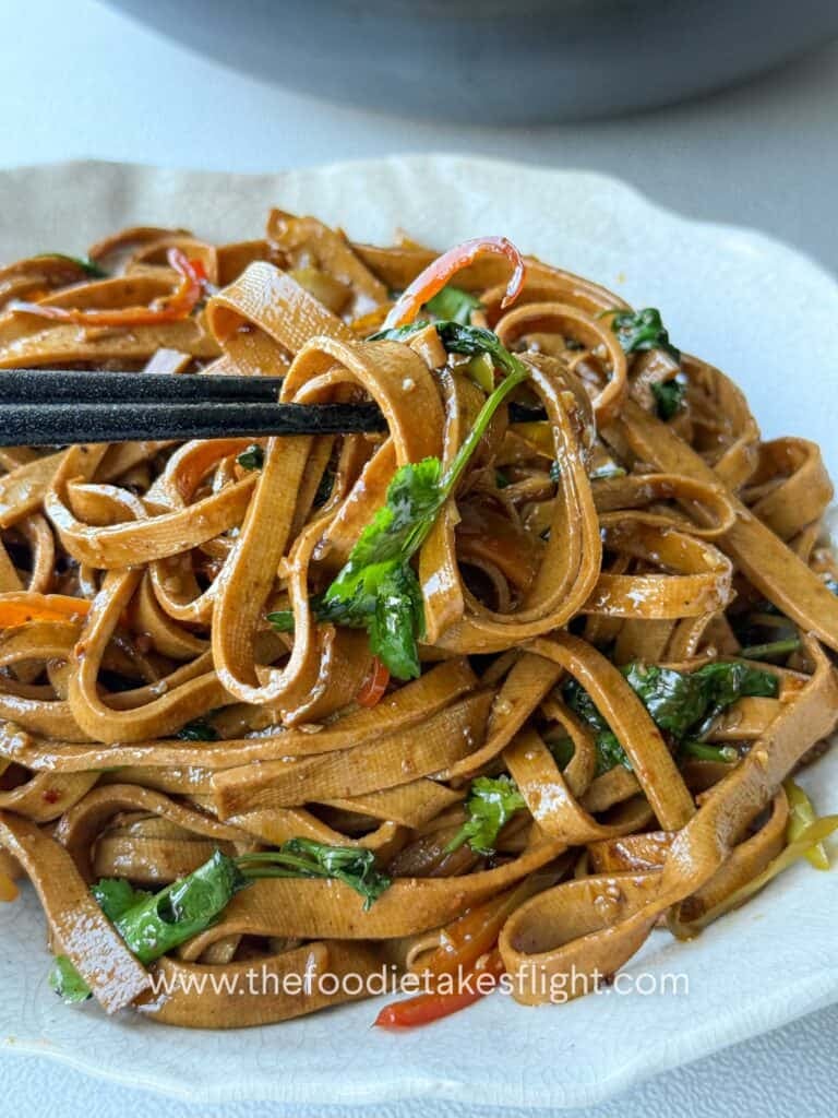 vegan tofu skin noodles in a glossy soy-based stir-fry sauce