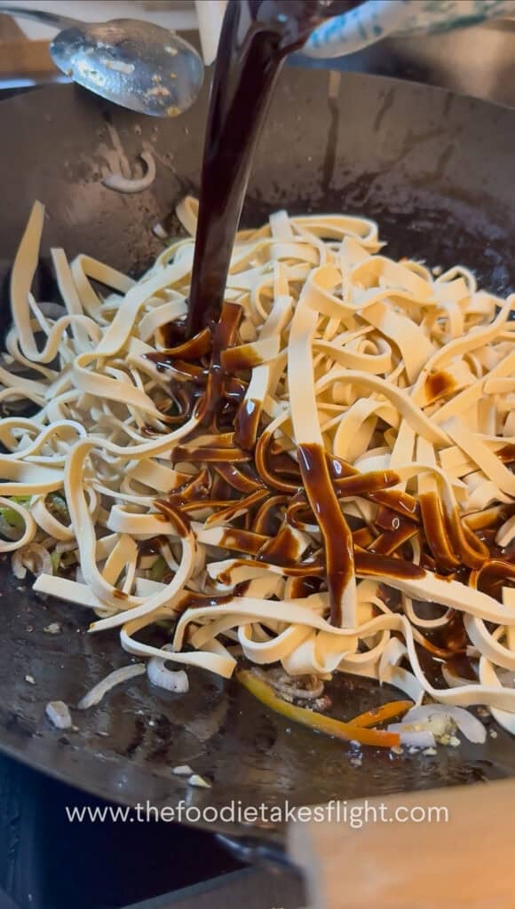 pouring the sauce over the tofu noodles
