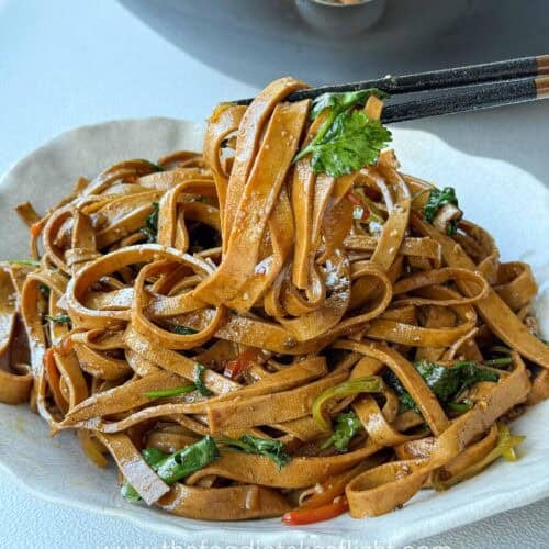 stir-fried beancurd sheets served in a bowl with cilantro