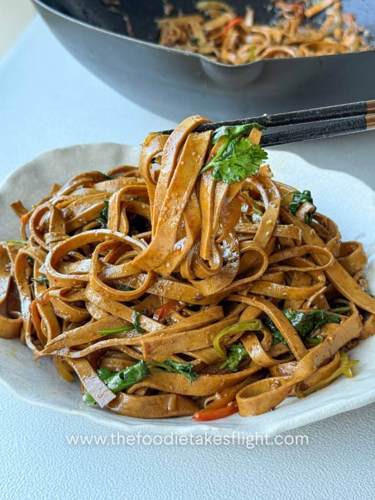 stir-fried beancurd sheets served in a bowl with cilantro