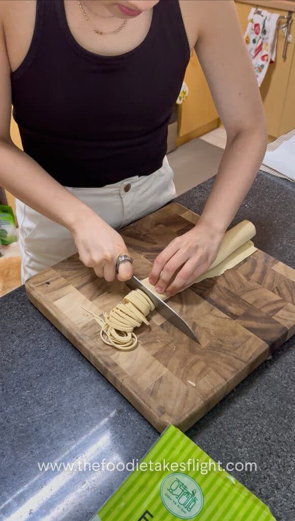 slicing rolled up beancurd skin or sheets into noodles