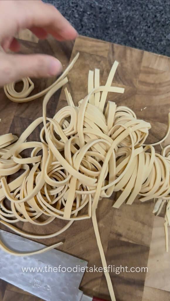 slicing rolled up beancurd skin or sheets into noodles
