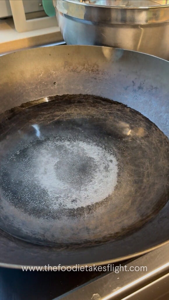 wok with water for blanching the tofu noodles