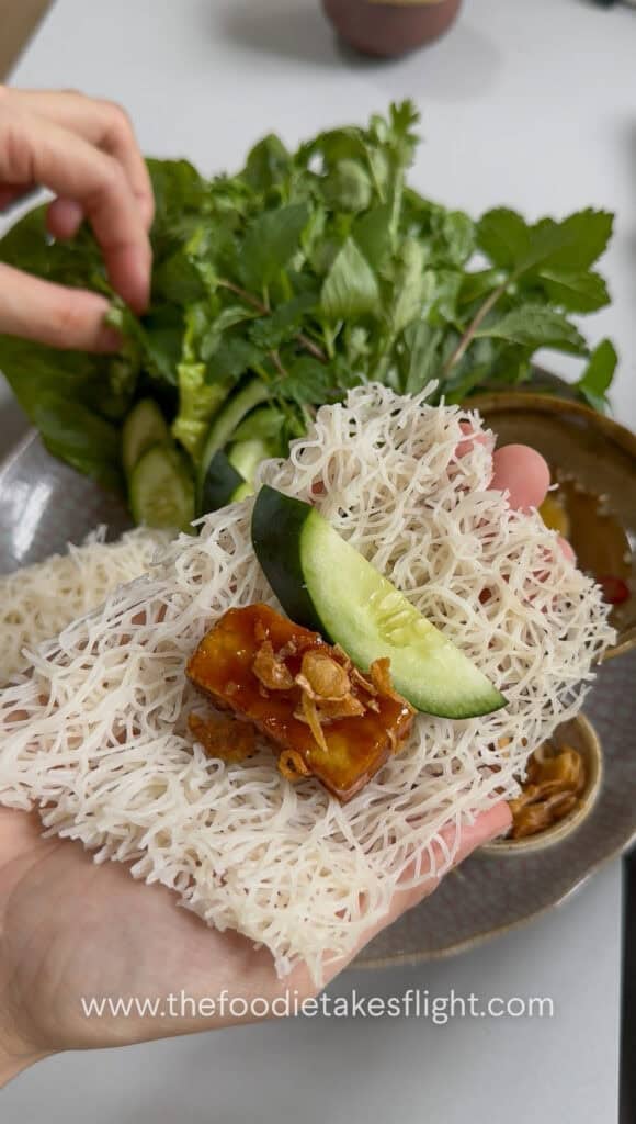 Hoisin tofu wrapped with banh hoi, lettuce, and fresh herbs