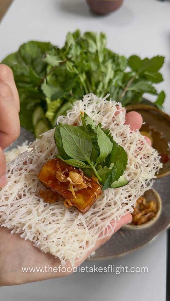 Hoisin tofu wrapped with banh hoi, lettuce, and fresh herbs