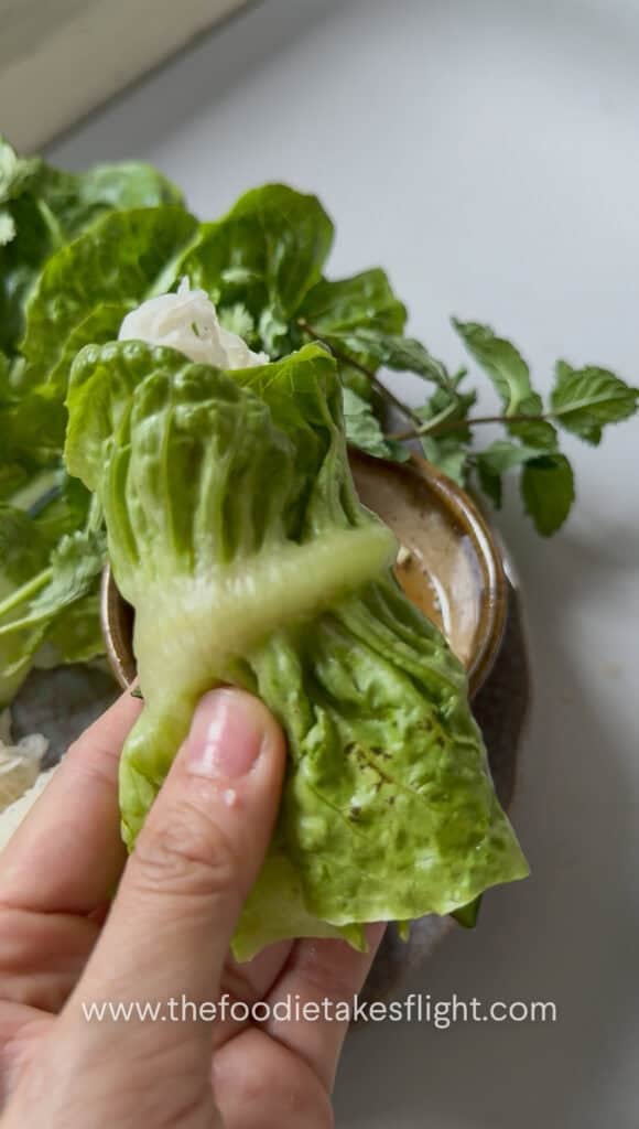 Hoisin tofu wrapped with banh hoi, lettuce, and fresh herbs