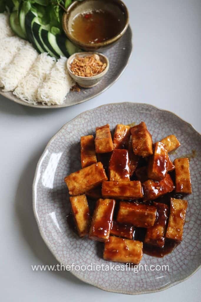 Golden hoisin glazed tofu pieces in a plate