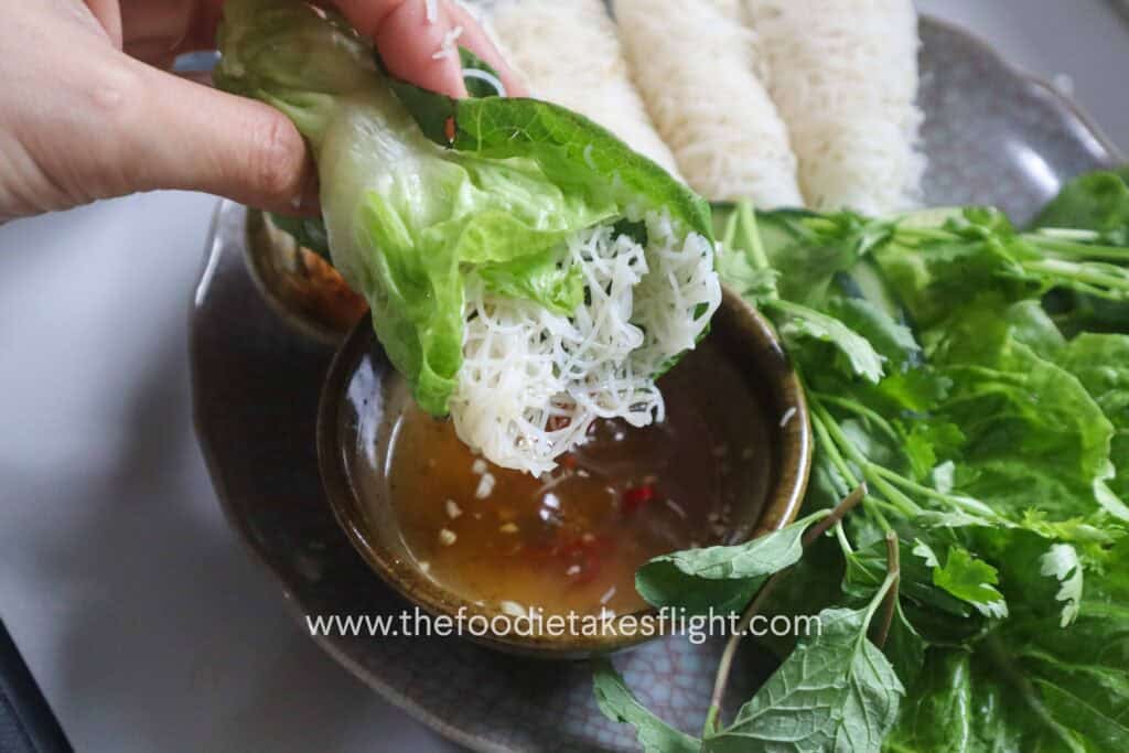 Hoisin tofu wrapped with banh hoi, lettuce, and fresh herbs