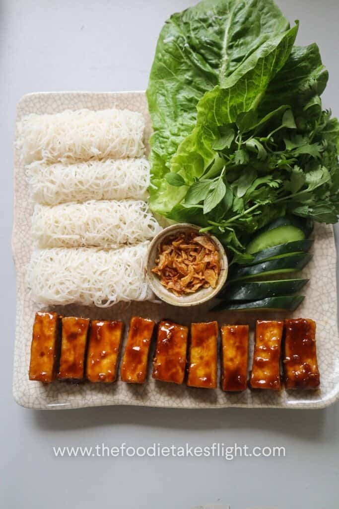 Banh hoi platter with hoisin tofu, lettuce, fresh herbs, and vegan nuoc cham