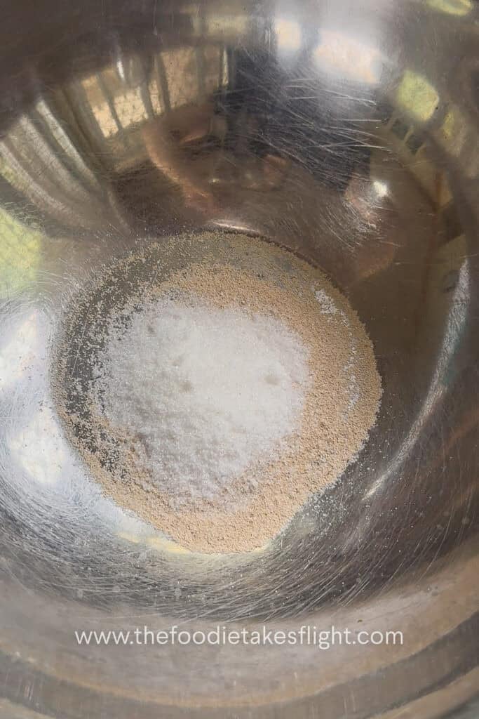 yeast and sugar in a stainless steel bowl