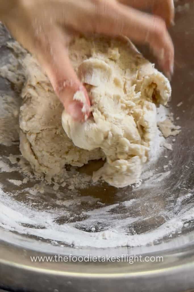 All-purpose flour, salt, olive oil, and yeast mixture combined into a shaggy pita dough