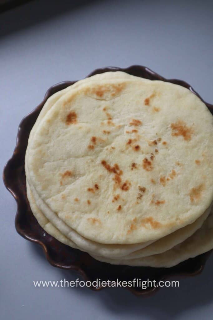 a stack of soft fluffy pita bread on a plate