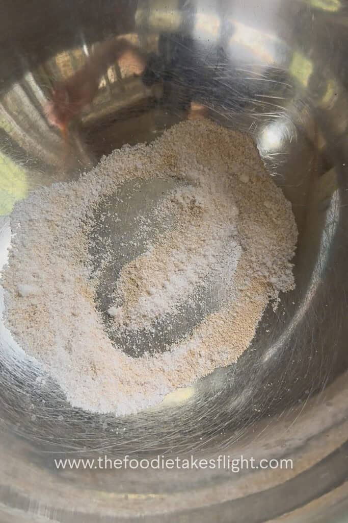yeast and sugar in a stainless steel bowl
