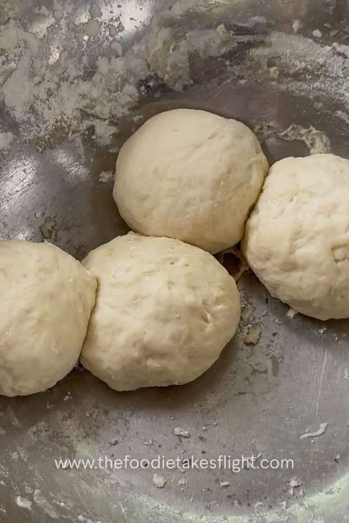 Pita dough divided into small balls before rolling into flatbreads