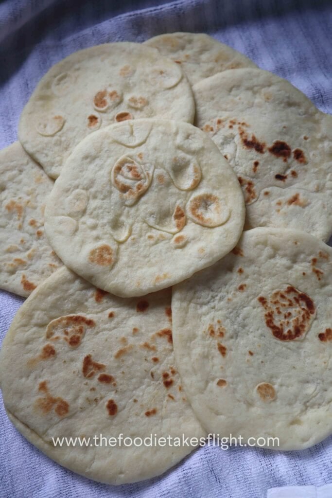 Easy homemade pita bread with soft, fluffy texture and golden brown spots