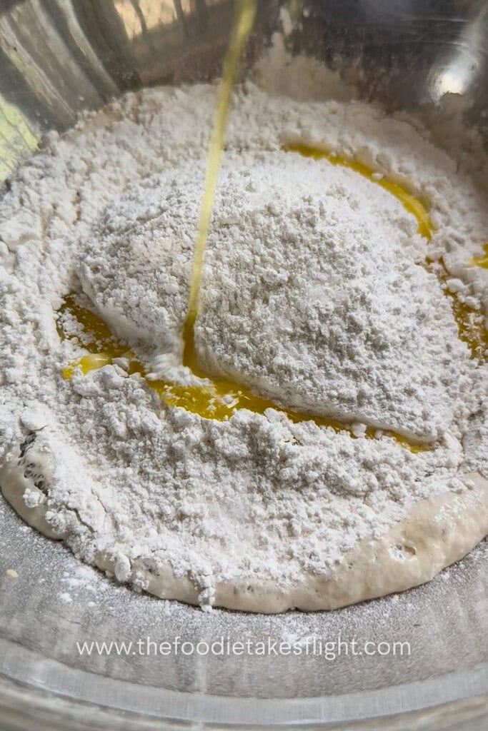 All-purpose flour, salt, olive oil, and yeast mixture combined into a shaggy pita dough