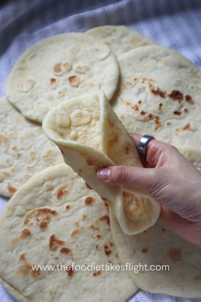 Easy homemade pita bread with soft, fluffy texture and golden brown spots