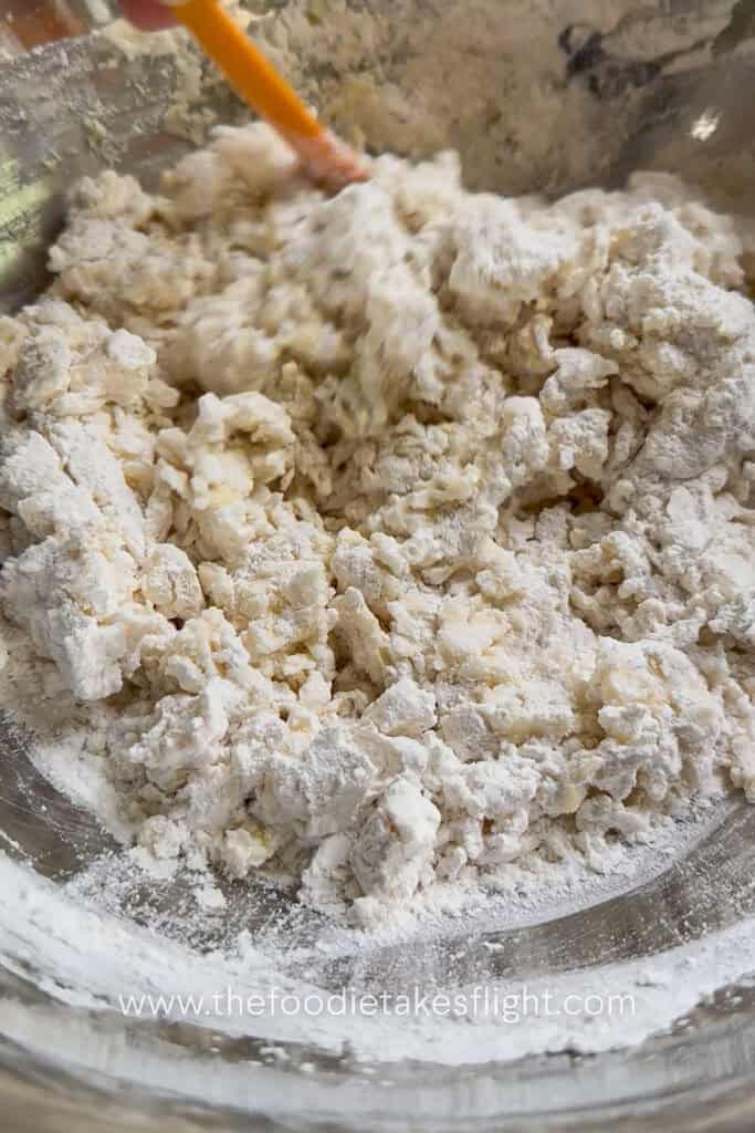 All-purpose flour, salt, olive oil, and yeast mixture combined into a shaggy pita dough