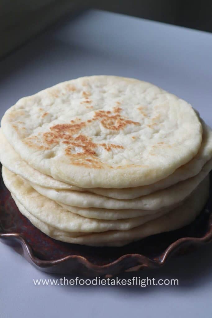 a stack of soft fluffy pita bread on a plate